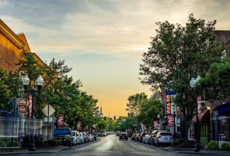 Main Street - landscape photography of vehicles parked on side of a street