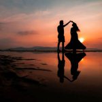 Couple Sunset - silhouette of man and woman kissing on beach during sunset