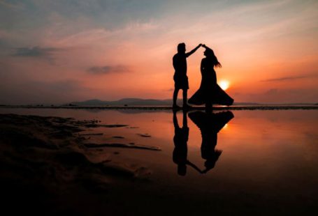 Couple Sunset - silhouette of man and woman kissing on beach during sunset