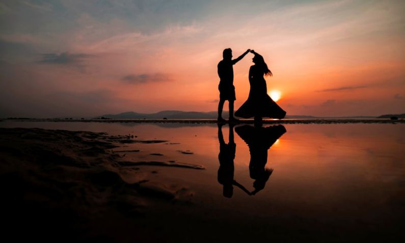 Couple Sunset - silhouette of man and woman kissing on beach during sunset