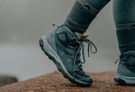 Hiking Boots - person in gray nike running shoes