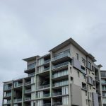 Shopping District - an apartment building with balconies and balconies on the second floor