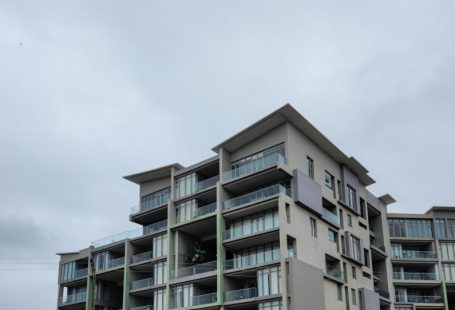 Shopping District - an apartment building with balconies and balconies on the second floor