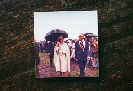 Historic Tour - a man and woman walking down a path with an umbrella