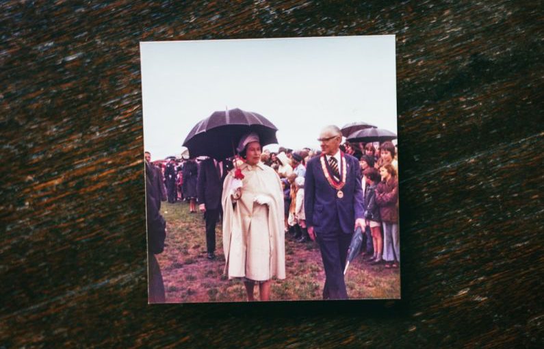 Historic Tour - a man and woman walking down a path with an umbrella