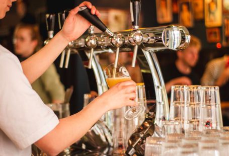 Brewery - person holding handle of faucet