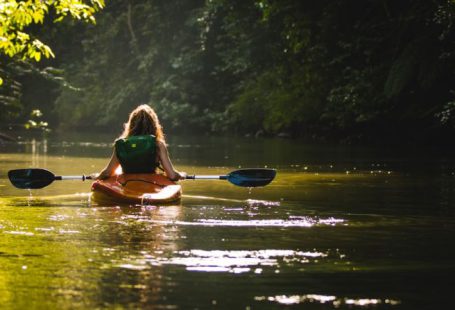 Kayaking - woman on kayak on body of water holding paddle