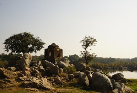 Heritage Site - a stone structure sitting on top of a lush green field