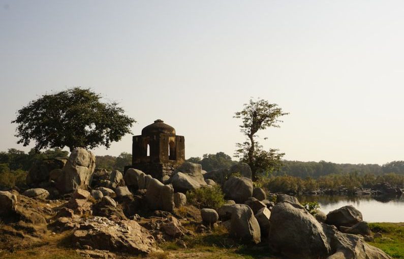 Heritage Site - a stone structure sitting on top of a lush green field