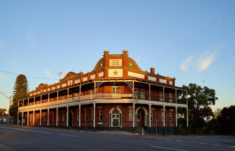 Historic Hotel - brown concrete building under blue sky during daytime