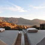 Boutique Hotel - sunloungers fronting buildings near mountain