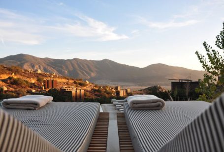 Boutique Hotel - sunloungers fronting buildings near mountain