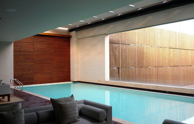Spa Hotel - two gray sofas beside pool in room