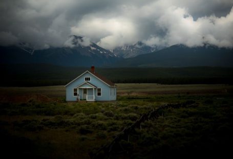 Secluded Stay - house on grass field under gray sky
