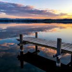 Waterfront - brown wooden dock on calm water during daytime