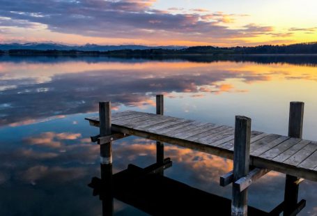 Waterfront - brown wooden dock on calm water during daytime