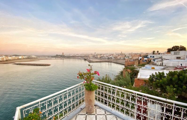 Balcony View - white metal fence near body of water during daytime
