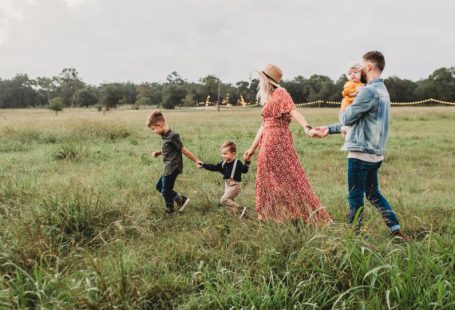 Family Fun - woman holding man and toddler hands during daytime