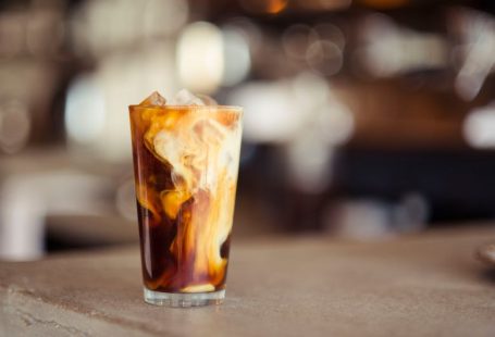 Coffee Café - glass cup filled with ice latte on tabletop