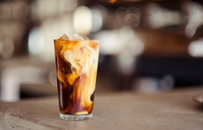 Coffee Café - glass cup filled with ice latte on tabletop