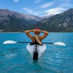 Adventure Sports - woman riding kayak at the middle of the sea