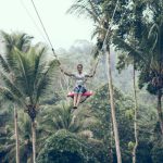 Zipline - woman using brown rope hammock during daytime