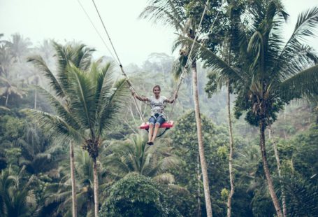 Zipline - woman using brown rope hammock during daytime