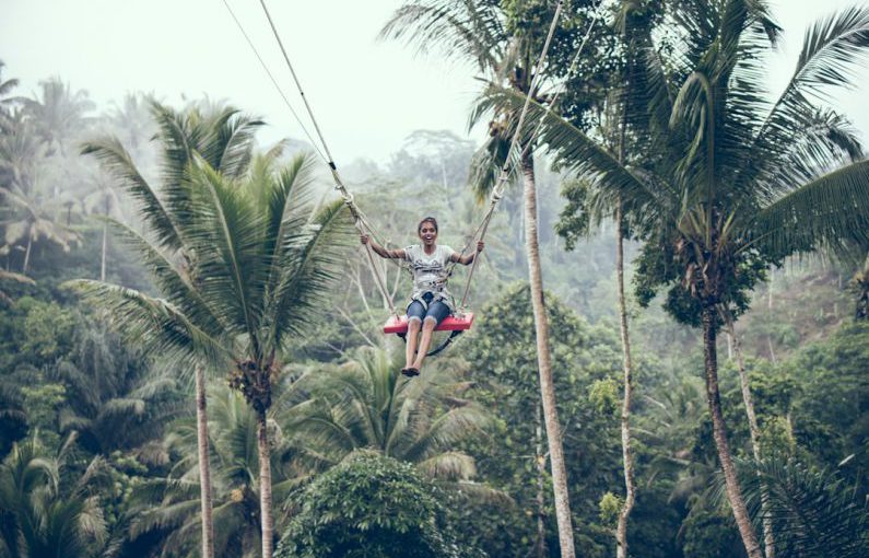 Zipline - woman using brown rope hammock during daytime