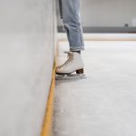 Ice Skating - person wearing white and gray skate shoes inside ice skating rink