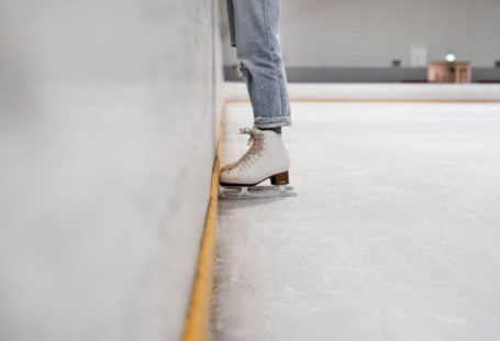 Ice Skating - person wearing white and gray skate shoes inside ice skating rink