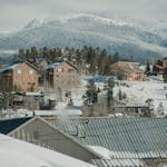 Scenic winter view of Breckenridge, Colorado with snow-covered houses and mountains.