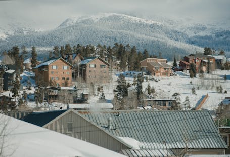 Scenic winter view of Breckenridge, Colorado with snow-covered houses and mountains.