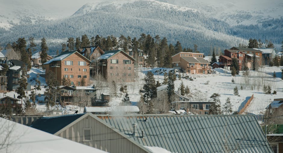 Scenic winter view of Breckenridge, Colorado with snow-covered houses and mountains.